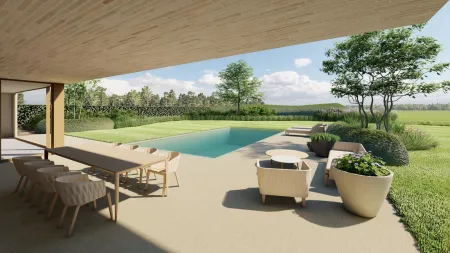 Overdekt terras met eettafel en loungehoek, direct grenzend aan het zwembad in de tuin.