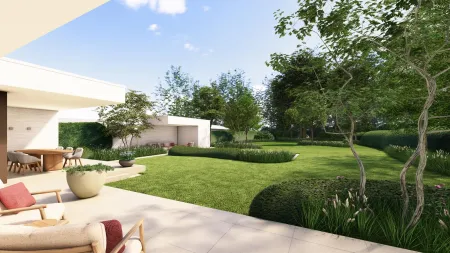 Loungehoek tussen strak geschoren hagen, met zicht op de rustige tuin in Rijmenam.